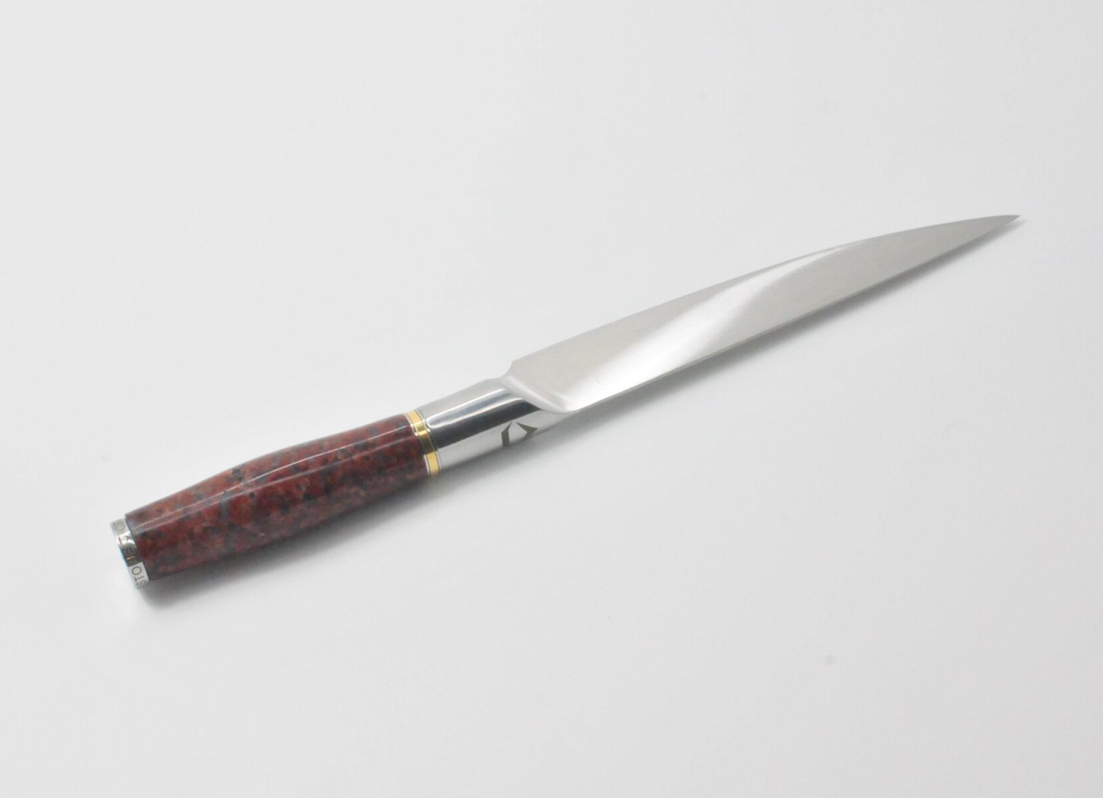 7 Inch Utility Knife with a Red Granite Handle, a Garnet Colored Cubic Zirconia Stone at the Back of the Knife and Brass and Stainless Steel Decorative Rings