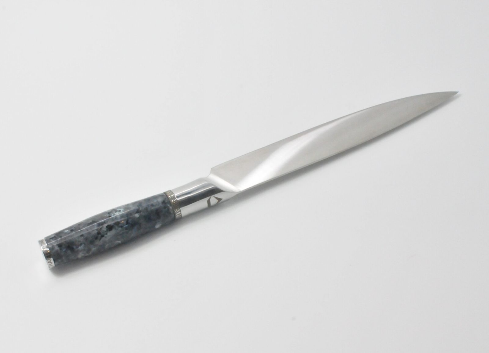 8 Inch Carving Knife with a Moonlight Grey Granite Handle, Aqua Blue Cubic Zirconia at the Back of the Knife and a Stainless Steel Engraved Aztec Decorative Ring