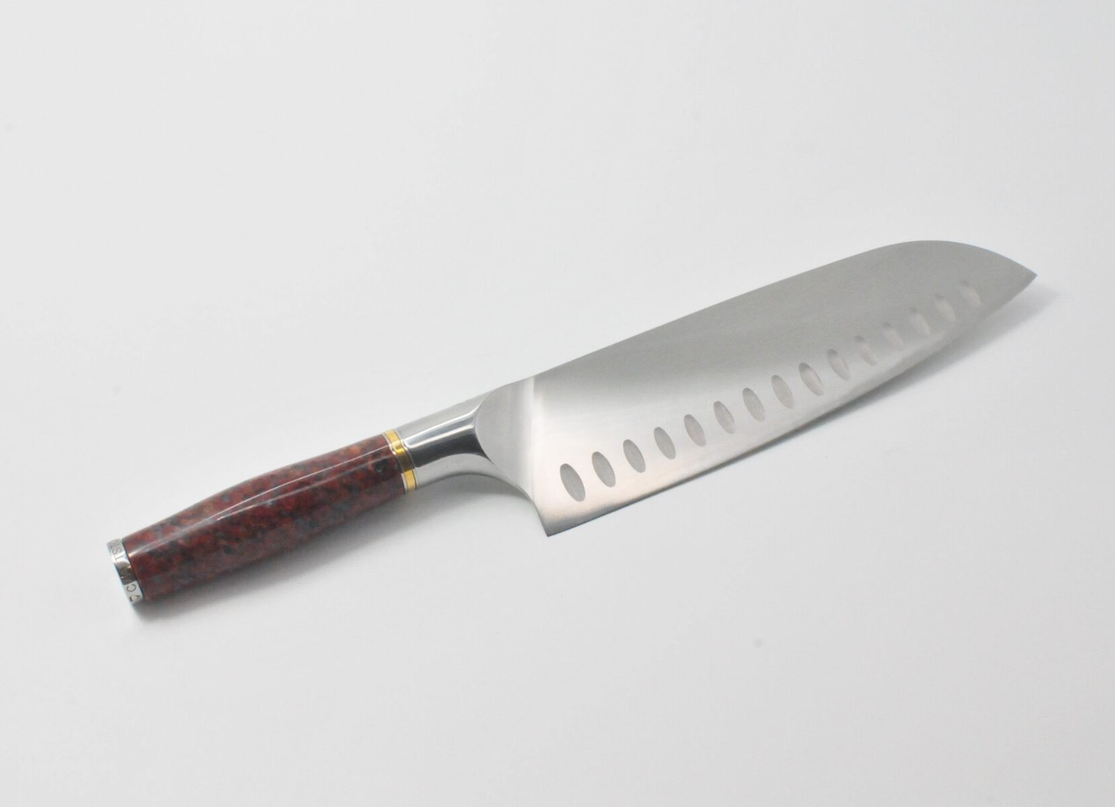8 Inch Santoku Knife with a Red Granite Handle, a Garnet Colored Cubic Zirconia Stone at the Back of the Knife and Brass and Stainless Steel Decorative Rings