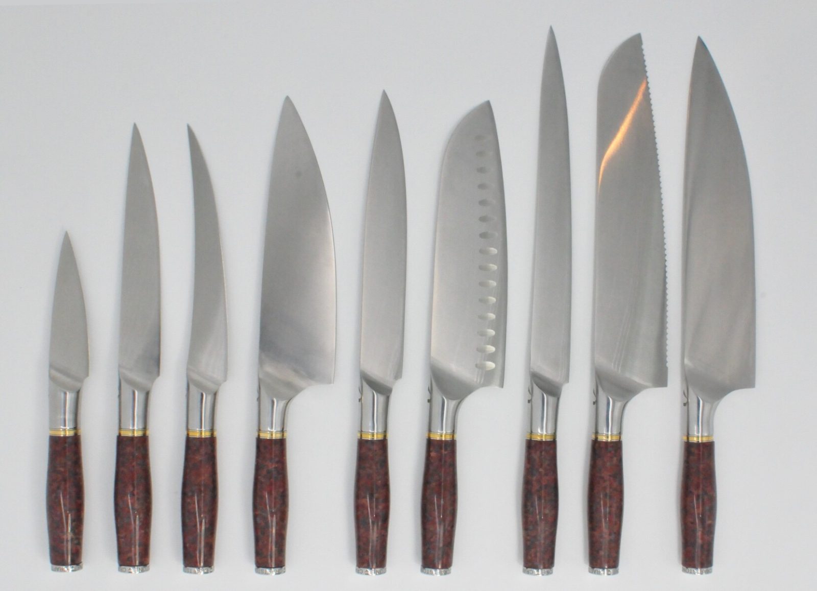 9 Knife Set with a Red Granite Handle, a Garnet Colored Cubic Zirconia Stone at the Back of the Knife and Brass and Stainless Steel Decorative Rings